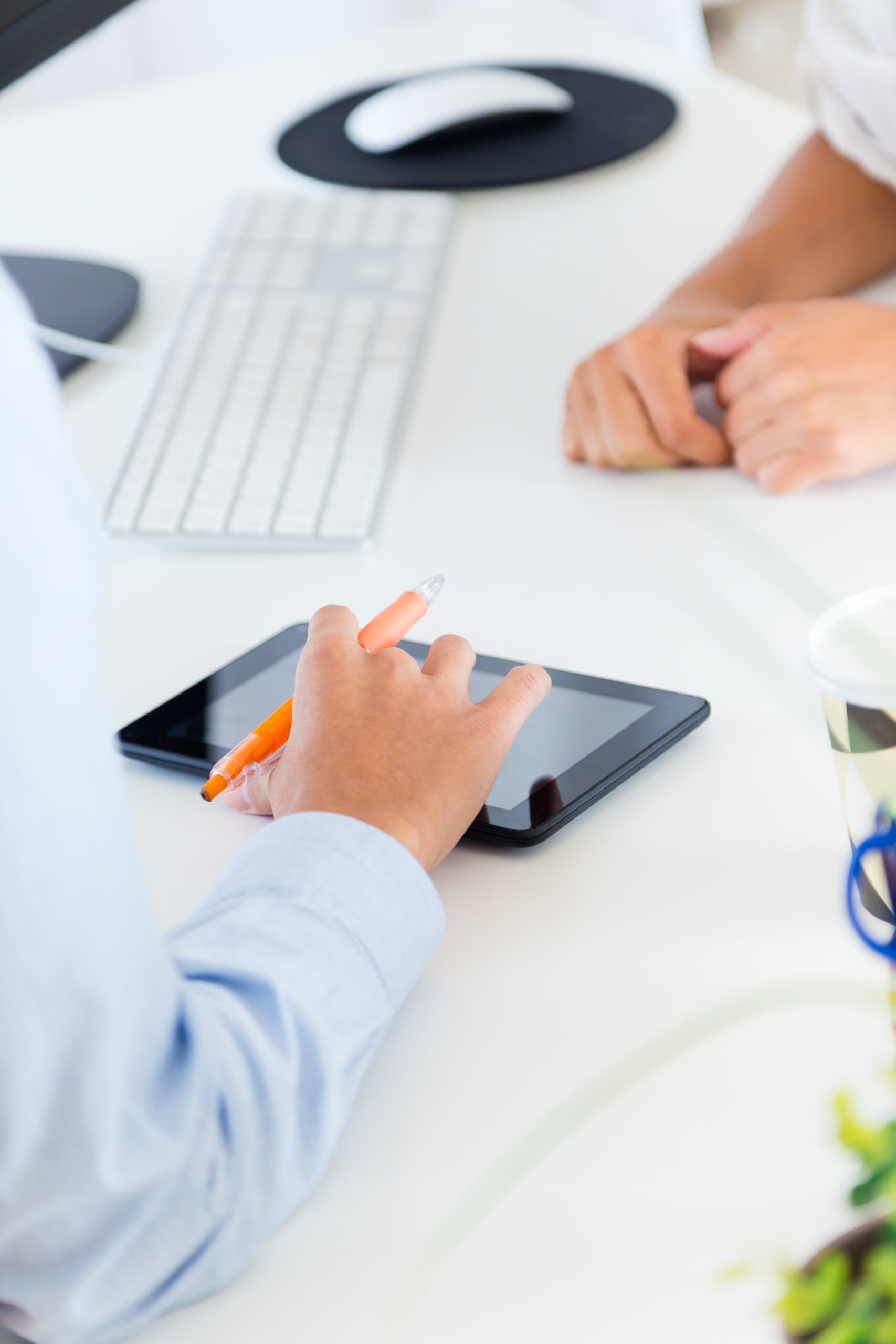 Two business woman working in office with digital tablet.